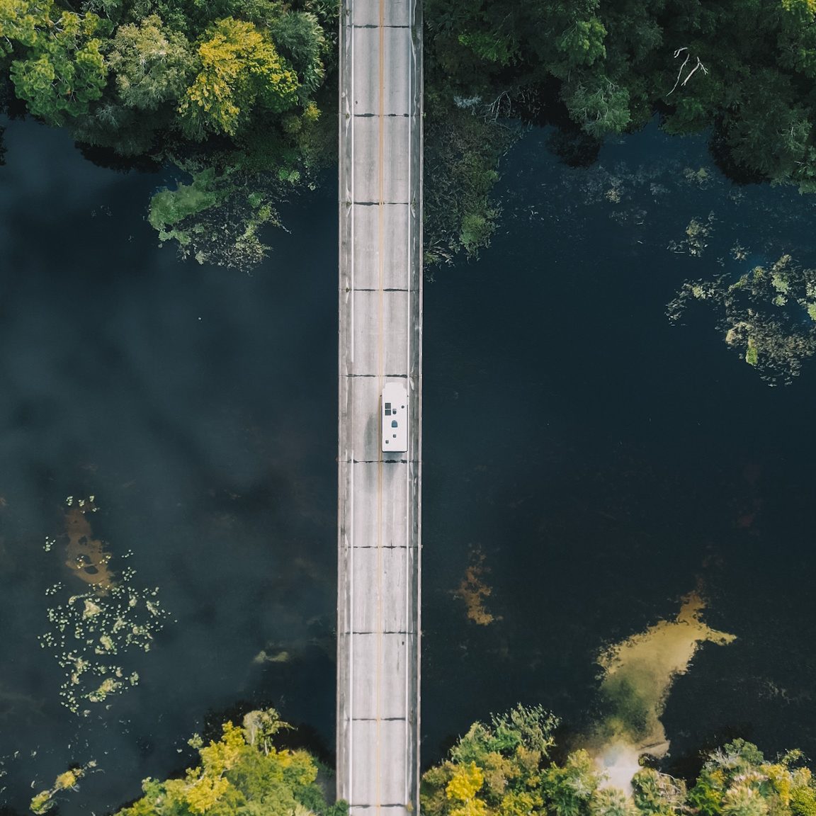 RV road trip birdesye view through forest